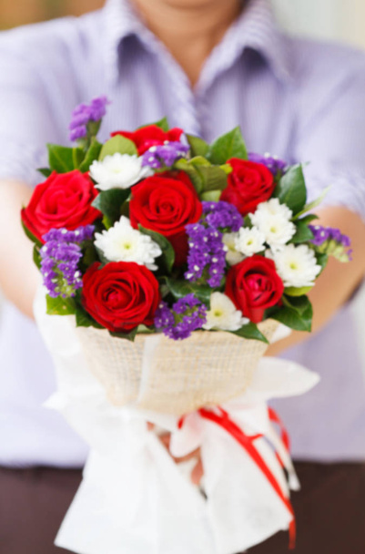 Blurry of Woman holding a bouquet of roses in hand for Valentine - Photo, Image
