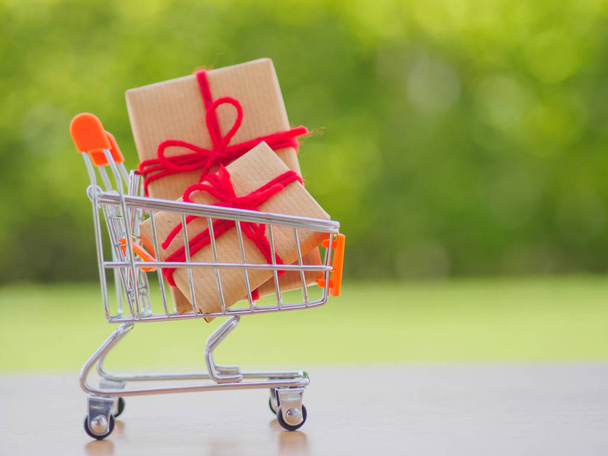 Celebration concept. Many New Year and Christmas presents or gifts represented in shopping cart - Fotoğraf, Görsel