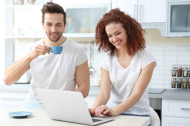 couple with laptop in kitchen - Foto, Imagem