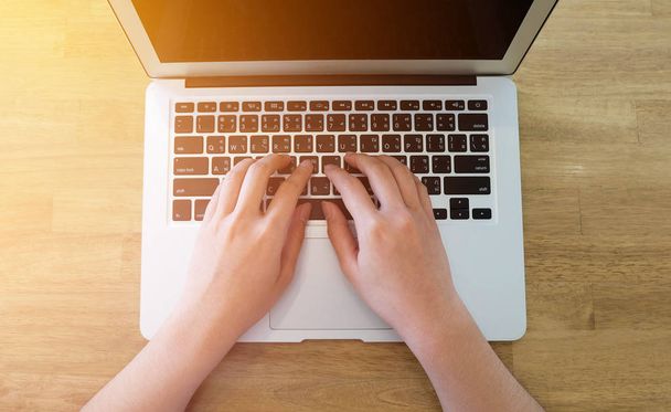 Woman office worker is typing keyboard of laptop, business or le - Фото, зображення