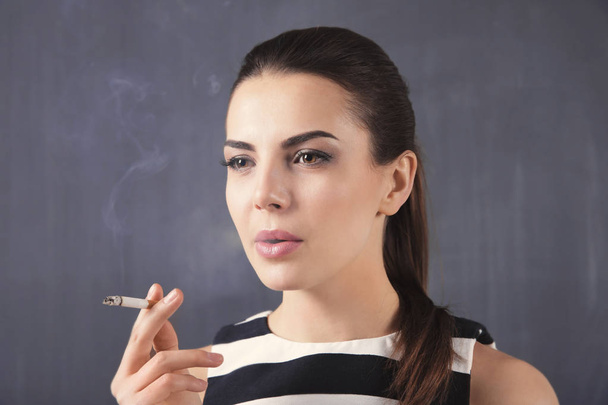 Young woman smoking cigarette  - Photo, Image