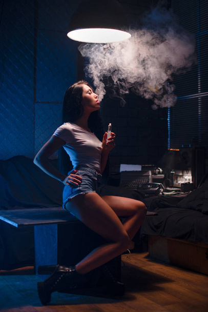 portrait of sexy woman in lingerie vaping e-cigarette , vape mod concept - Zdjęcie, obraz