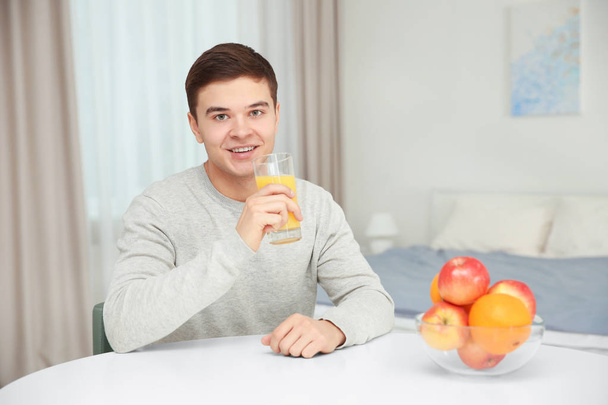 Young man drinking juice  - Фото, изображение