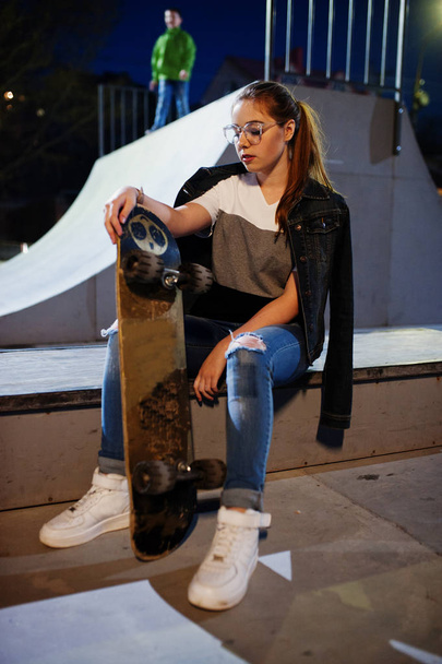 Young teenage urban girl with skateboard, wear on glasses, cap a - Foto, Imagen