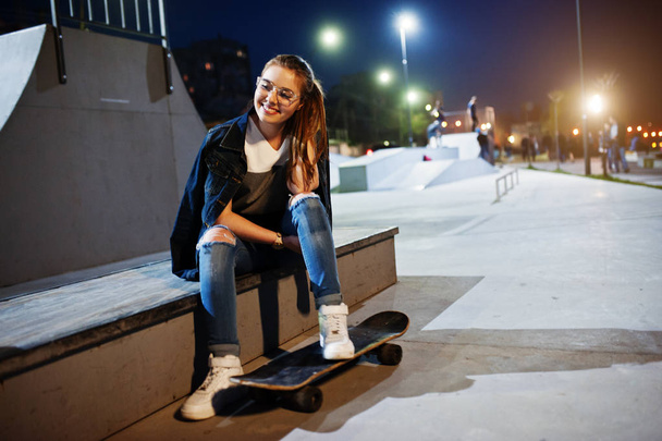 Young teenage urban girl with skateboard, wear on glasses, cap a - Valokuva, kuva