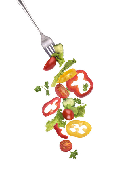 Salad on a fork on a white background - Fotó, kép