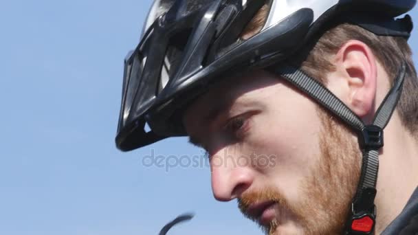 cyclist wearing bicycle helmet against the sky - Footage, Video