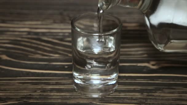 Poured a glass of vodka, close-up . Full hd video - Materiaali, video