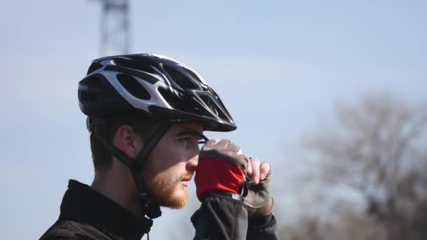 professional cyclist with a beard wearing glasses - Footage, Video