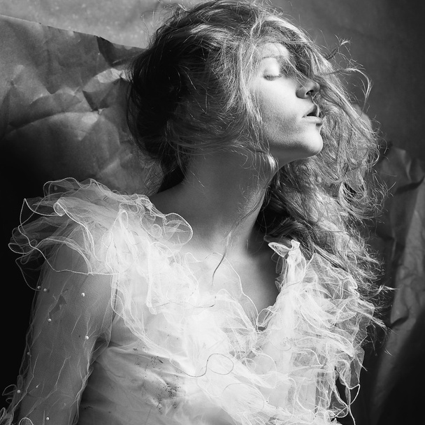 Retro portrait of a dreaming queen like girl over wrinkled black - Fotografie, Obrázek