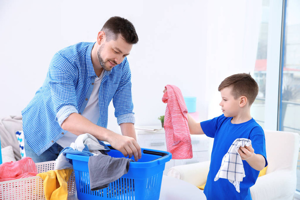 Dad and son preparing clothes  - Фото, изображение