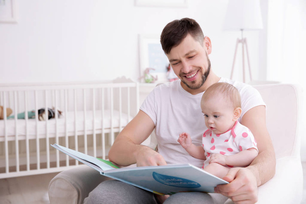 Father showing book to cute baby   - Foto, immagini