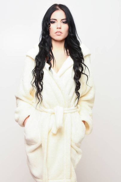 sexy girl posing in beige velour bathrobe - Фото, зображення