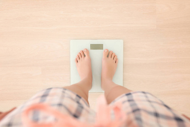  woman standing on scales - Photo, image