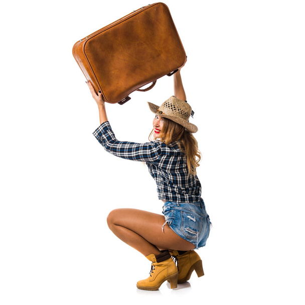 Sexy blonde woman cowgirl with vintage suitcase - Fotó, kép