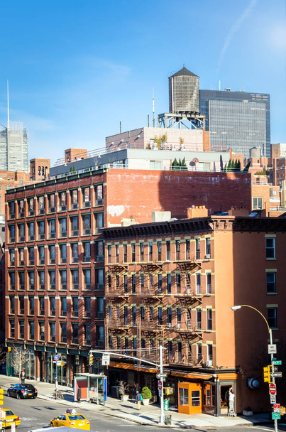 Brick Buildings with a Rooftop Water Tank in New York - Fotografie, Obrázek