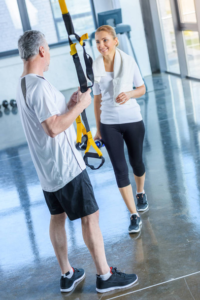 sportswoman and sportsman with resistance band - Photo, Image