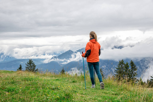 Young woman hiking in the mountains - 写真・画像