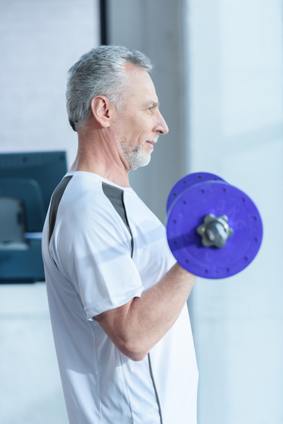 Mature sportsman with barbell  - Photo, image