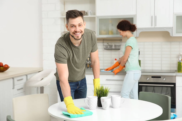 young couple cleaning kitchen  - Φωτογραφία, εικόνα