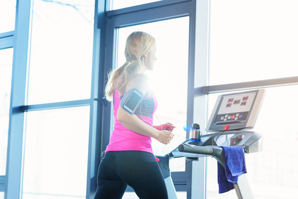 Sporty woman on treadmill  - Photo, Image