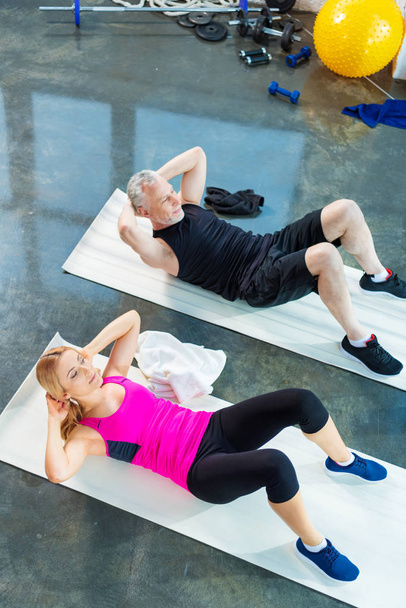 Sporty man and woman in gym  - Фото, изображение