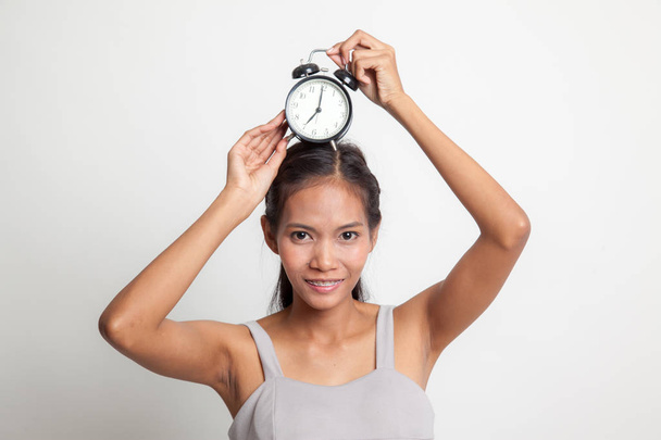 Young Asian woman smile with a clock. - Photo, Image
