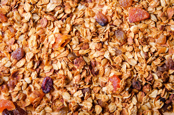 Homemade granola with honey, oatmeal, nuts, raisin, cranberry and dried apricots - Fotó, kép