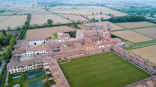 Luchtfoto van de Certosa di Pavia, gebouwd in de late 14e eeuw, de rechtbanken en het klooster van het klooster en het heiligdom in de provincie van Pavia, Lombardia, Italië - Foto, afbeelding