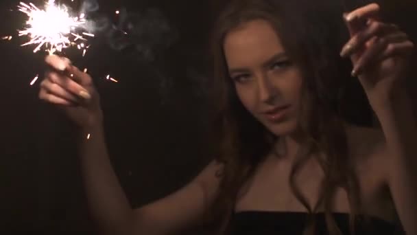 portrait of attractive girl with sparklers. cute beautiful girl dancing at the party - Video, Çekim