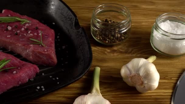 Beef fillet on a pan with pepper, rosemary, axe and garlic. - Séquence, vidéo