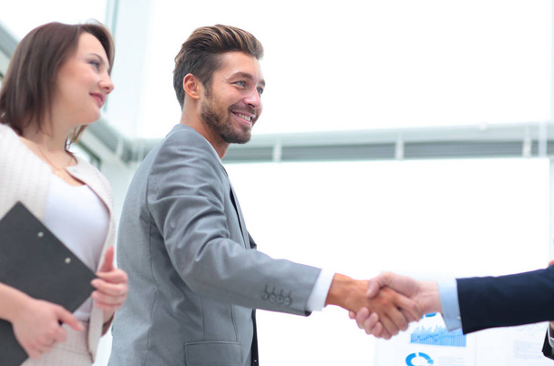 Two business people shaking hands with each other in the office - Photo, Image
