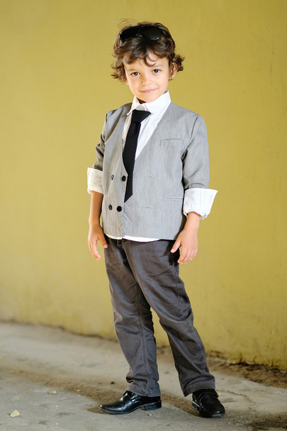Portrait of little stylish boy outdoors in a suit - Foto, Imagem