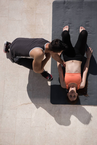 woman with personal trainer doing morning yoga exercises top vie - Foto, Bild