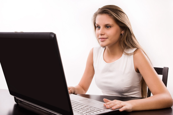 Astonished girl behind a laptop - Photo, Image