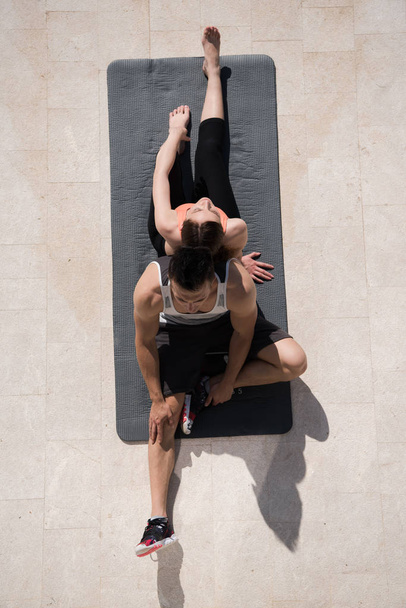 woman with personal trainer doing morning yoga exercises top vie - Fotografie, Obrázek