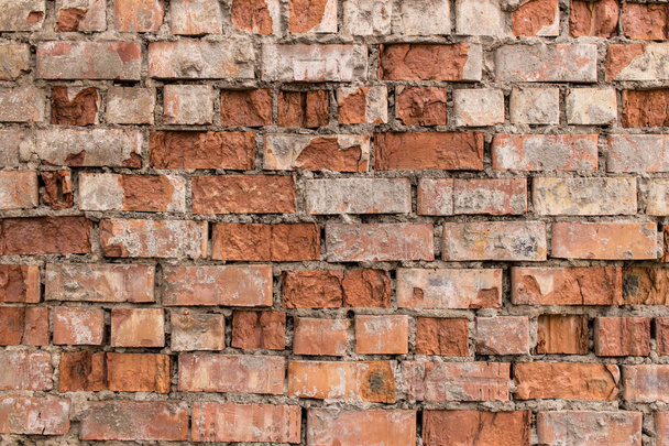 Fragment of old brick wall made of red brick. - Foto, afbeelding