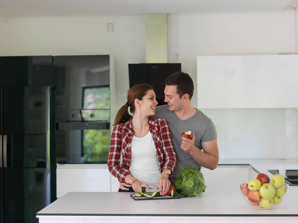 Young handsome couple in the kitchen - Foto, imagen