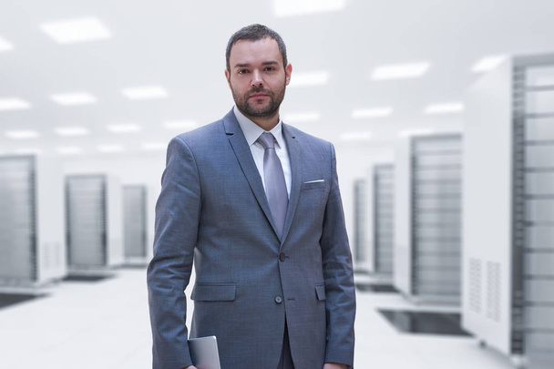 Young businessman in server room - 写真・画像