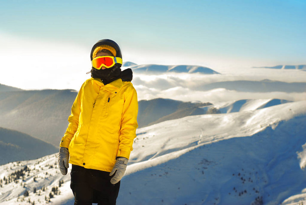girl in snowboard equipment against the backdrop of snow-capped  - Фото, изображение