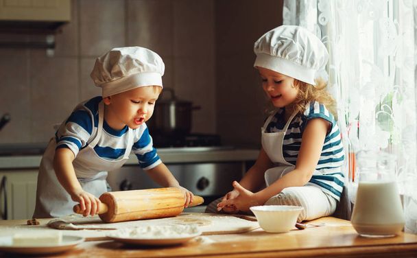 happy family funny kids bake cookies in kitchen - Foto, afbeelding