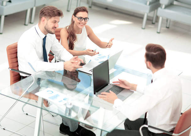 Business people working around table in modern office - Foto, imagen