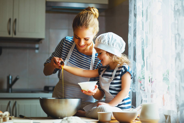happy family in kitchen. mother and child preparing dough, bake  - Photo, Image