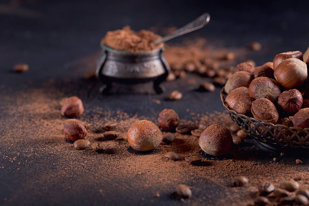 Hazelnut, coffee beans and cocoa powder in dark background. - Fotoğraf, Görsel