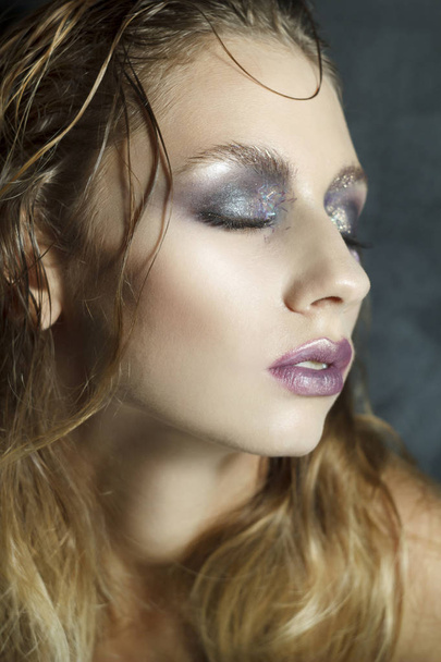 Beauty portrait of a young blond girl with smoky eyes makeup. Ar - Фото, изображение