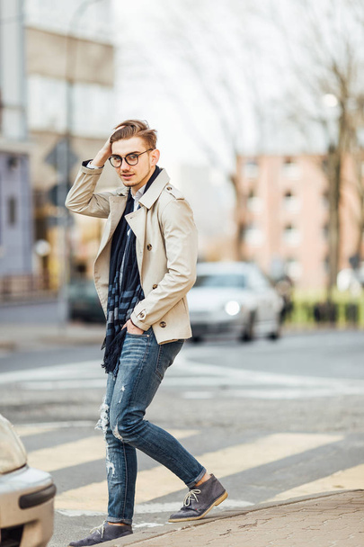 Fashionable man walking on the street with blur background - Fotó, kép