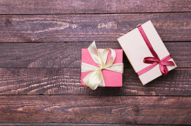 red and gold gift box on wood background. - Foto, immagini