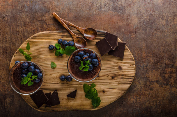Chocolate pudding with berries and herbs - Фото, изображение