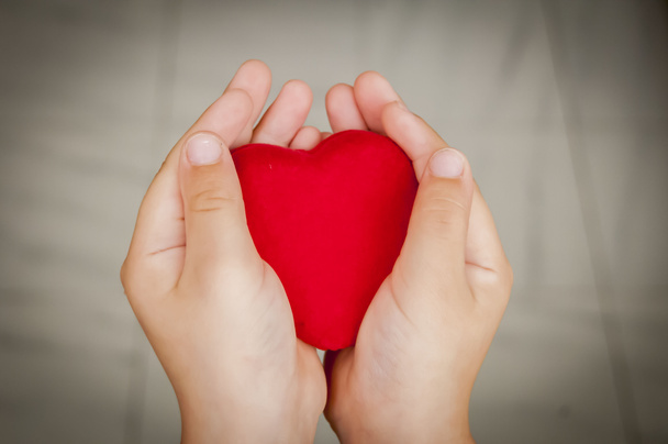 Heart in child hands stock image. - Fotó, kép