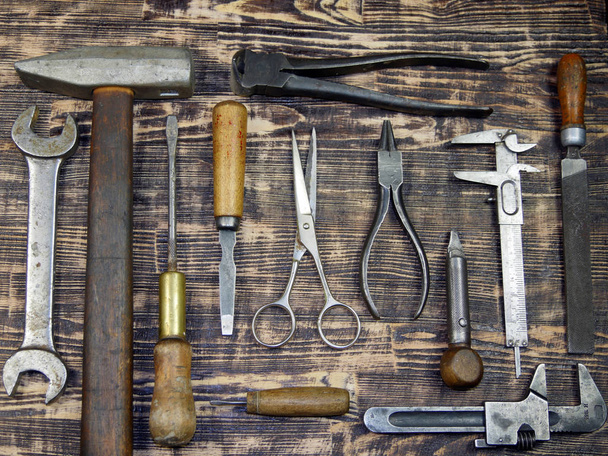 vintage tools displayed on a background of brown barnboard. - Photo, Image